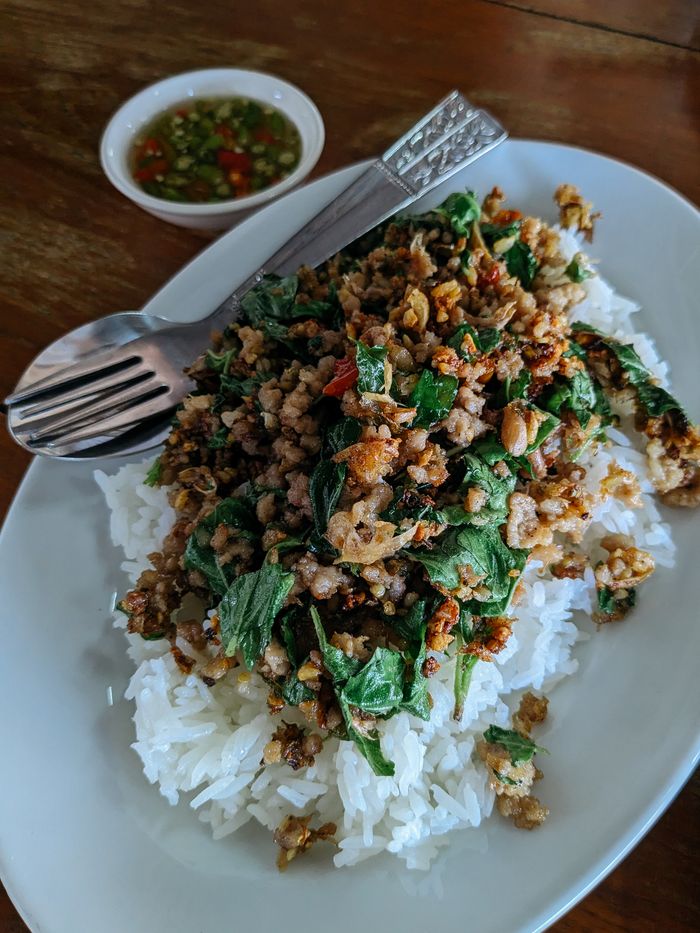 about-us-01 Flavorful Thai basil minced pork served on steamed rice with spicy sauce.