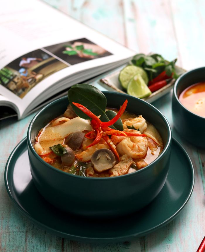 services-01 Close-up of delicious Tom Yum soup, a traditional Thai dish, beautifully presented.